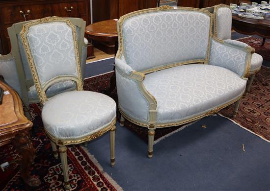 A Louis XVI style five piece salon suite, with carved silvered frames, comprising a sofa, a pair of fauteuil and a pair of boudoir chai